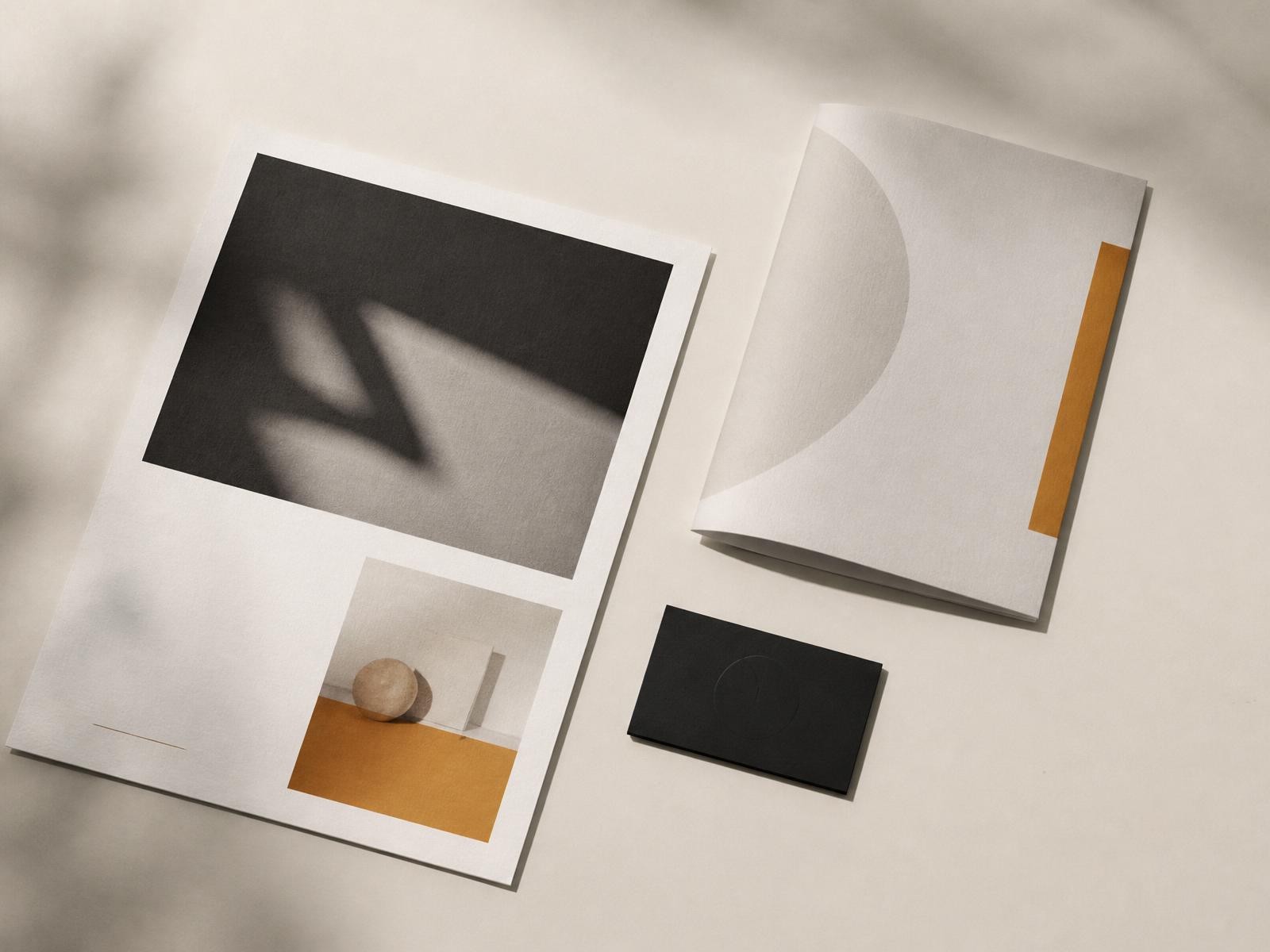 Printed AdMosaic campaign collateral arranged on a warm ivory surface